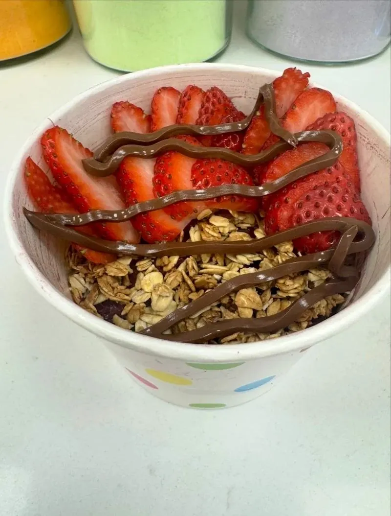 Açaí bowl with strawberries and chocolate drizzle