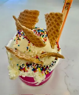 Ice cream with sprinkles and waffle pieces