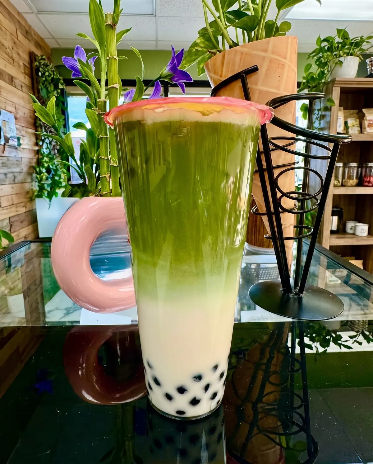 Layered iced matcha latte with boba