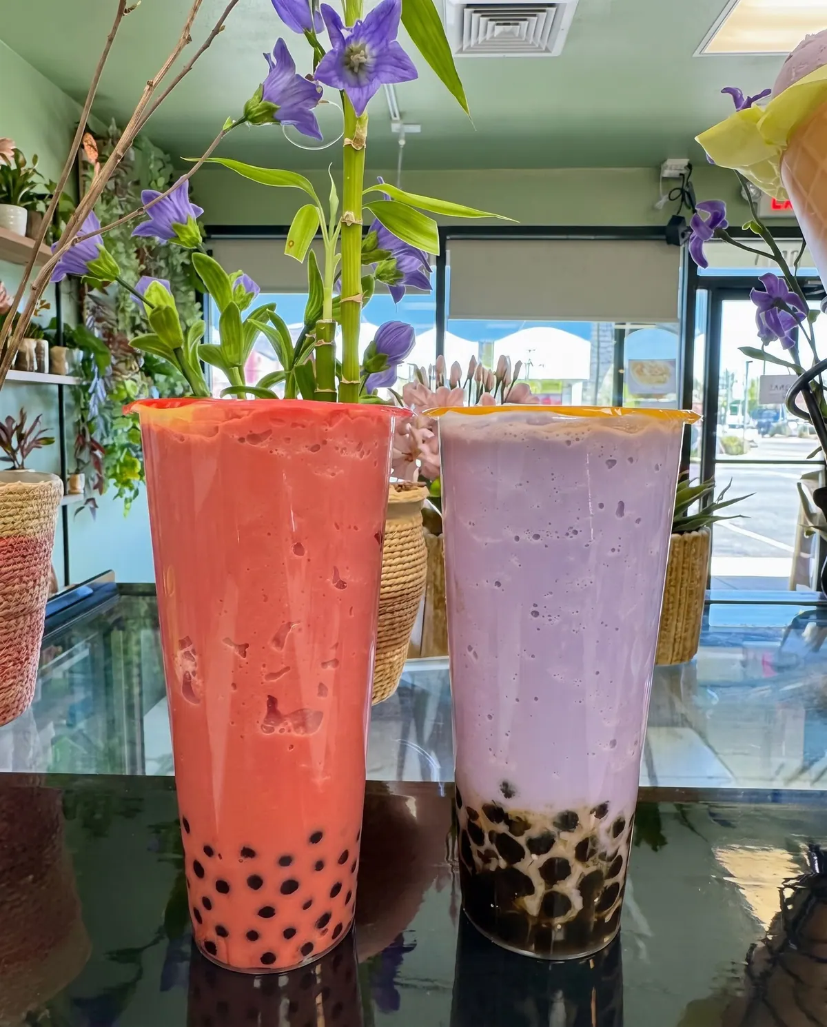 Strawberry and taro blended milk teas with boba