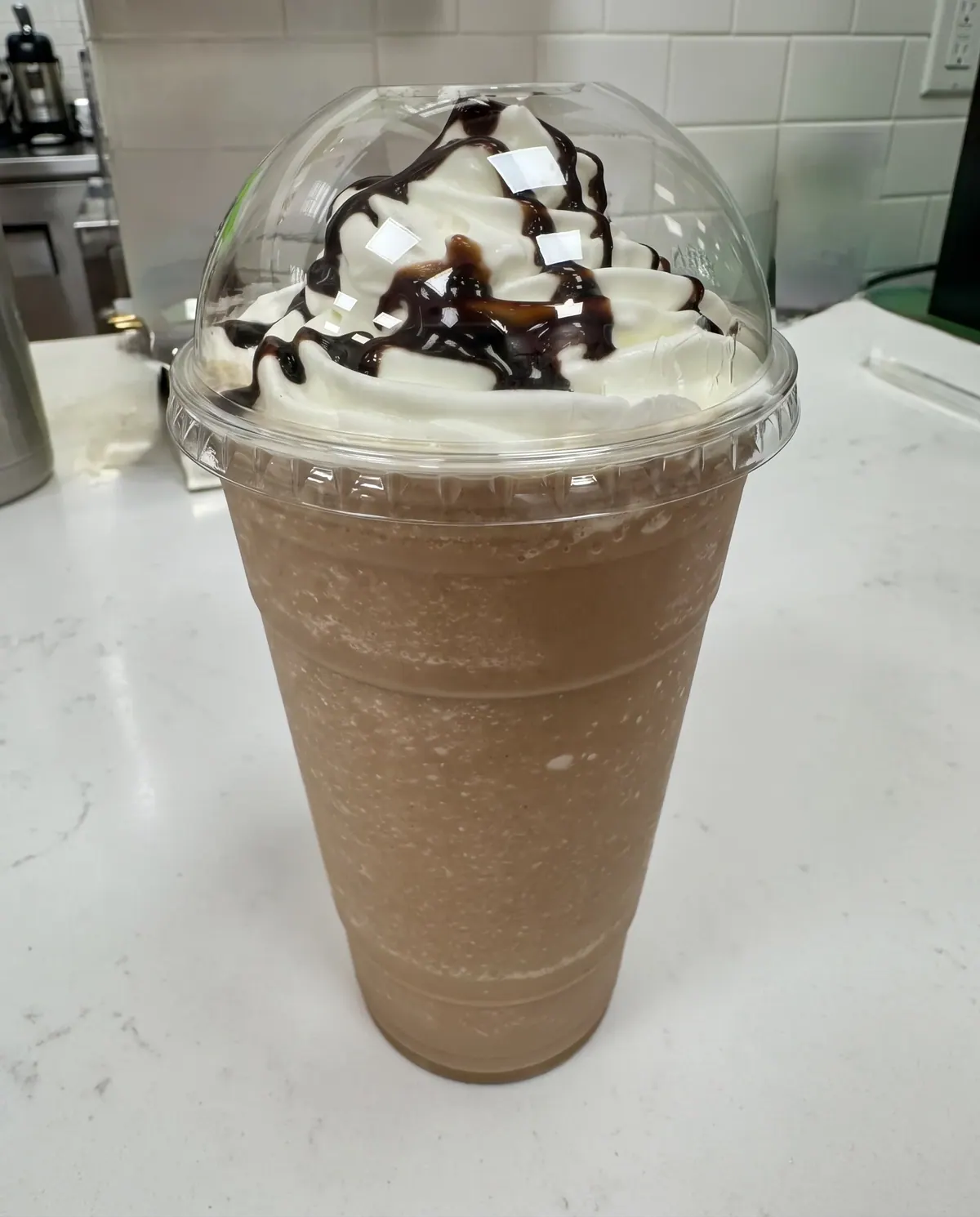 Chocolate milkshake with whipped cream and chocolate drizzle